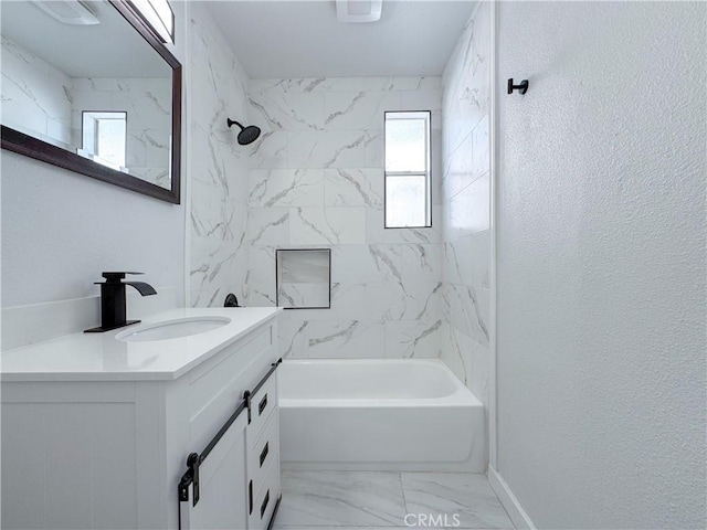 full bath with healthy amount of natural light, marble look tile flooring,  shower combination, and vanity
