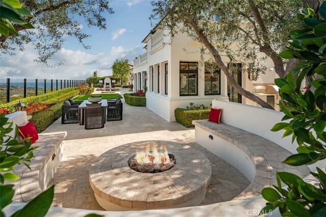 28 Shoreridge, Newport Coast, CA 92657 - view of patio / terrace featuring a fire pit, outdoor dining area, and a water view