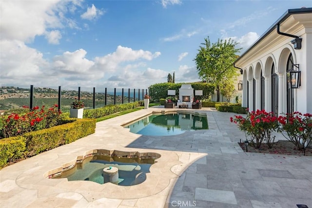 28 Shoreridge, Newport Coast, CA 92657 - view of swimming pool featuring a lit fireplace and a patio