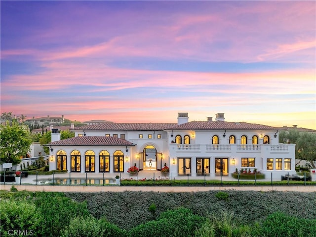 28 Shoreridge, Newport Coast, CA 92657 - rear view of house featuring a balcony, a chimney, and a patio