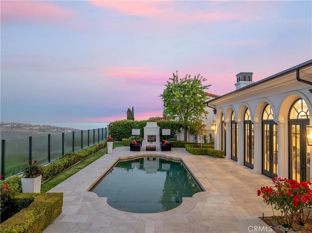 28 Shoreridge, Newport Coast, CA 92657 - view of pool featuring exterior fireplace, a patio, and a fenced backyard