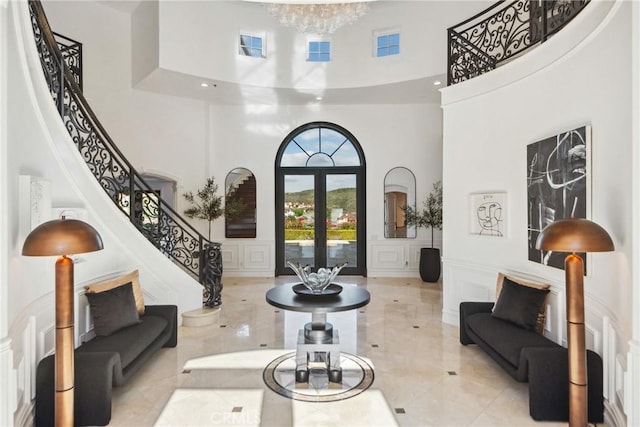 28 Shoreridge, Newport Coast, CA 92657 - foyer entrance featuring a high ceiling, a decorative wall, stairs, marble tiled flooring, and a wainscoted wall
