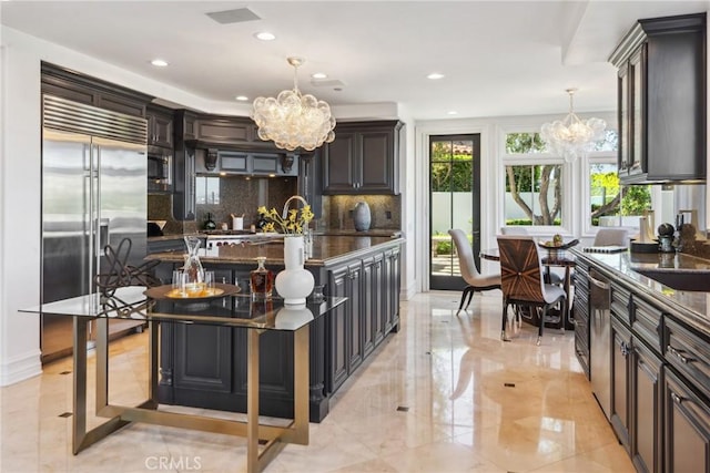 28 Shoreridge, Newport Coast, CA 92657 - kitchen with a chandelier, built in appliances, decorative backsplash, recessed lighting, and decorative light fixtures