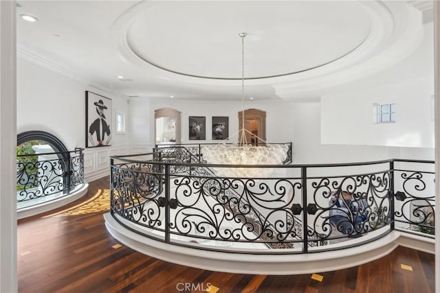 28 Shoreridge, Newport Coast, CA 92657 - corridor with an upstairs landing, ornamental molding, wood finished floors, recessed lighting, and a tray ceiling