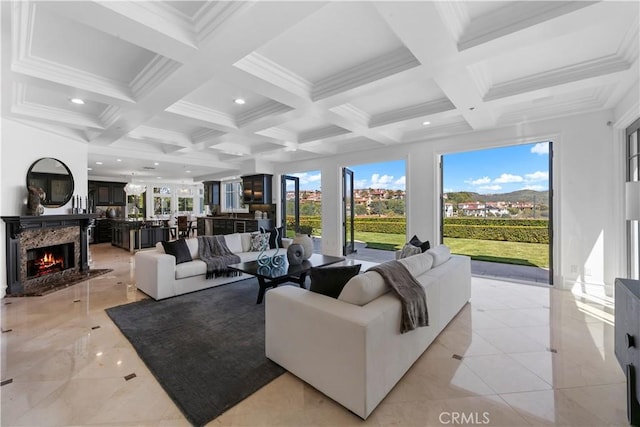 28 Shoreridge, Newport Coast, CA 92657 - living area featuring a high end fireplace, beamed ceiling, coffered ceiling, ornamental molding, and recessed lighting
