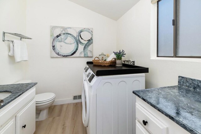 7321 Alicante Rd Unit A, Carlsbad, CA 92009 - bathroom featuring vanity, toilet, wood finished floors, lofted ceiling, and washer and dryer