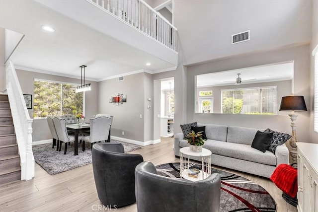 73 Melrose Dr, Mission Viejo, CA 92692 - living area with baseboards, stairway, light wood-style flooring, plenty of natural light, and crown molding