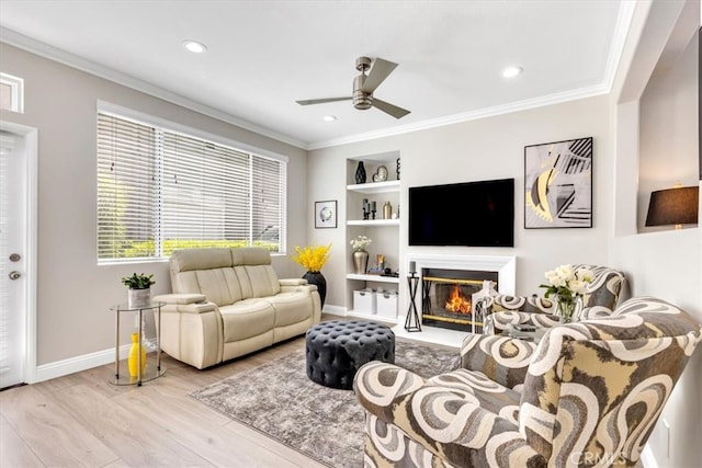 73 Melrose Dr, Mission Viejo, CA 92692 - living area with ceiling fan, wood finished floors, built in shelves, baseboards, and crown molding