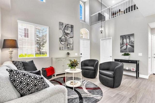 73 Melrose Dr, Mission Viejo, CA 92692 - living room featuring light wood-style floors, plenty of natural light, a high ceiling, and baseboards