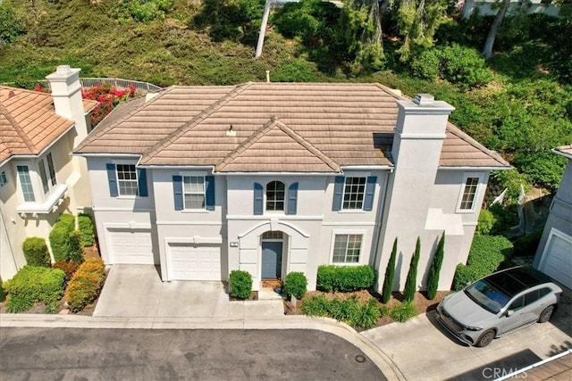 73 Melrose Dr, Mission Viejo, CA 92692 - view of front of house with concrete driveway, a tiled roof, an attached garage, and stucco siding