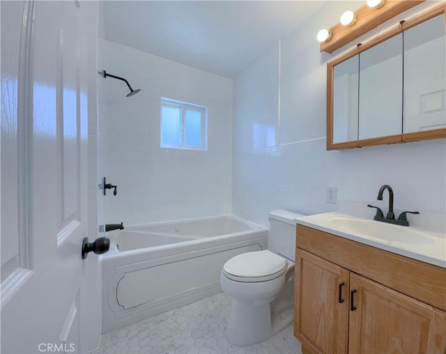 bathroom featuring toilet, vanity, washtub / shower combination, and tile patterned flooring