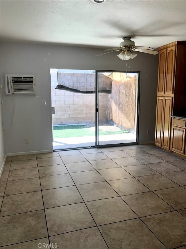 4185 E Grand Ave Unit A-B, Pomona, CA 91766 - unfurnished dining area featuring an AC wall unit, a ceiling fan, light tile patterned floors, baseboards, and a textured ceiling