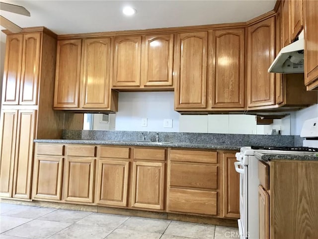 4185 E Grand Ave Unit A-B, Pomona, CA 91766 - kitchen featuring white range with gas cooktop, under cabinet range hood, a sink, light tile patterned floors, and dark stone counters