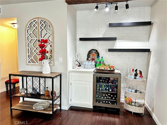 1512 W Sunnyview Dr, Rialto, CA 92377 - bar with beverage cooler, baseboards, dark wood-style flooring, and rail lighting