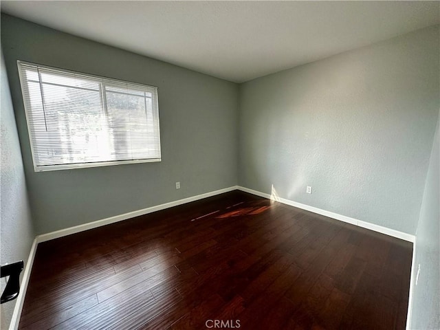 1512 W Sunnyview Dr, Rialto, CA 92377 - empty room with dark wood-type flooring and baseboards