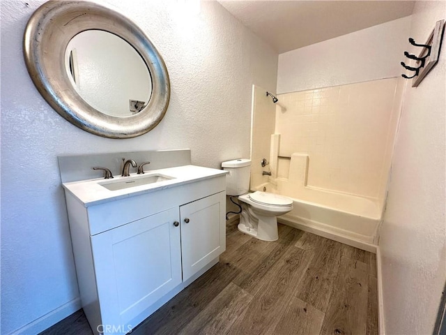 1512 W Sunnyview Dr, Rialto, CA 92377 - bathroom featuring wood finished floors, a textured wall, toilet, vanity, and shower / tub combination