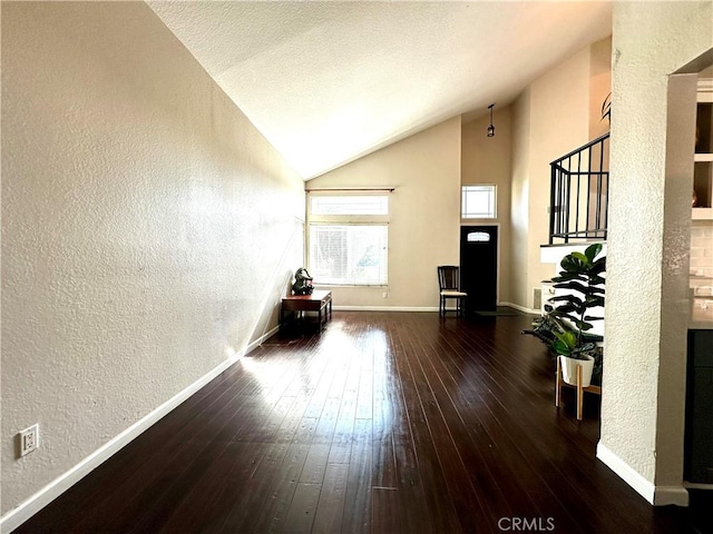1512 W Sunnyview Dr, Rialto, CA 92377 - living room featuring a textured wall, vaulted ceiling, hardwood / wood-style flooring, and baseboards