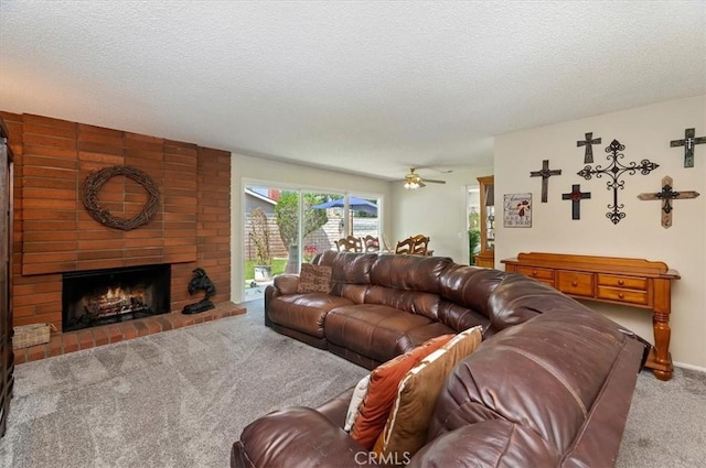carpeted living area with a fireplace, ceiling fan, and a textured ceiling