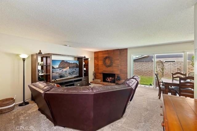 carpeted living room with a textured ceiling and a large fireplace