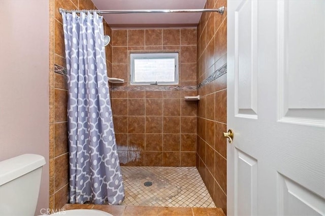 bathroom featuring a shower stall and toilet