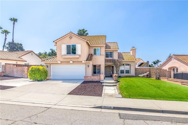 mediterranean / spanish house with a tile roof, stucco siding, an attached garage, driveway, and a chimney