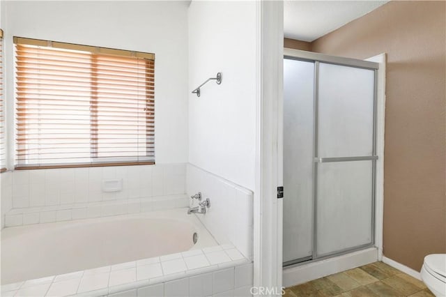full bathroom with a shower stall, toilet, and a bath