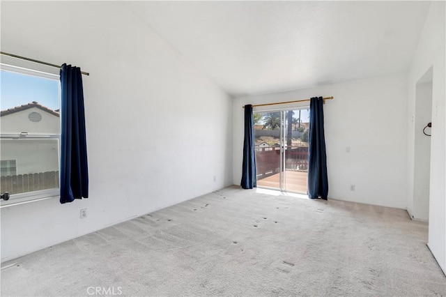 unfurnished room with lofted ceiling and carpet floors