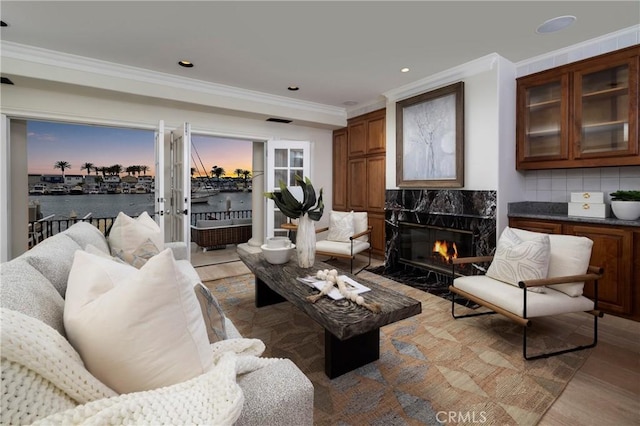 339 Via Lido Soud, Newport Beach, CA 92663 - living area with a premium fireplace, ornamental molding, light wood-style floors, a water view, and recessed lighting
