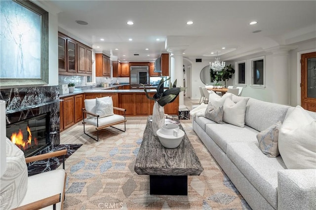 339 Via Lido Soud, Newport Beach, CA 92663 - living area featuring ornate columns, recessed lighting, a high end fireplace, and a chandelier