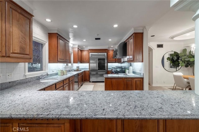 339 Via Lido Soud, Newport Beach, CA 92663 - kitchen featuring stainless steel appliances, wall chimney range hood, a sink, light stone counters, and recessed lighting