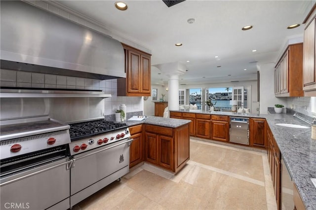 339 Via Lido Soud, Newport Beach, CA 92663 - kitchen featuring a peninsula, dishwasher, wall chimney exhaust hood, a sink, and decorative columns