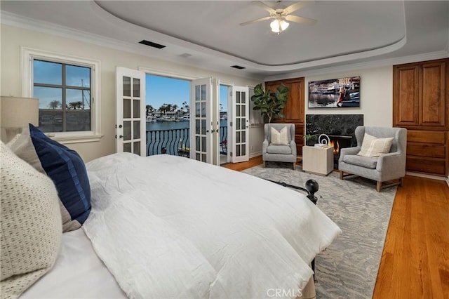 339 Via Lido Soud, Newport Beach, CA 92663 - bedroom with a raised ceiling, french doors, access to outside, light wood finished floors, and ceiling fan
