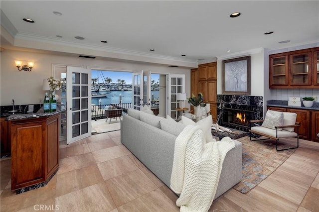 339 Via Lido Soud, Newport Beach, CA 92663 - living room with crown molding, a water view, french doors, a premium fireplace, and recessed lighting