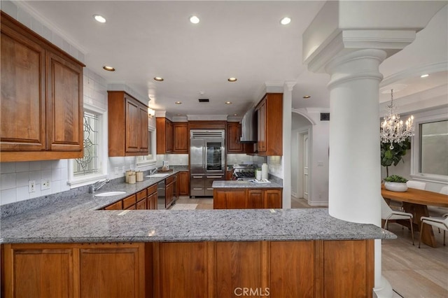 339 Via Lido Soud, Newport Beach, CA 92663 - kitchen featuring stainless steel appliances, a sink, light stone counters, brown cabinets, and recessed lighting