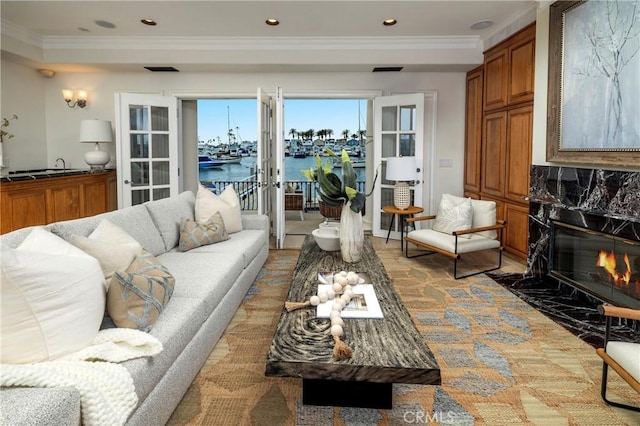 339 Via Lido Soud, Newport Beach, CA 92663 - living room featuring a water view, ornamental molding, a fireplace, french doors, and recessed lighting