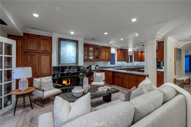 339 Via Lido Soud, Newport Beach, CA 92663 - living area with crown molding, arched walkways, recessed lighting, decorative columns, and a fireplace