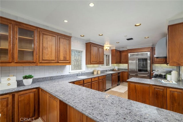 339 Via Lido Soud, Newport Beach, CA 92663 - kitchen featuring appliances with stainless steel finishes, tasteful backsplash, brown cabinetry, light stone countertops, and recessed lighting
