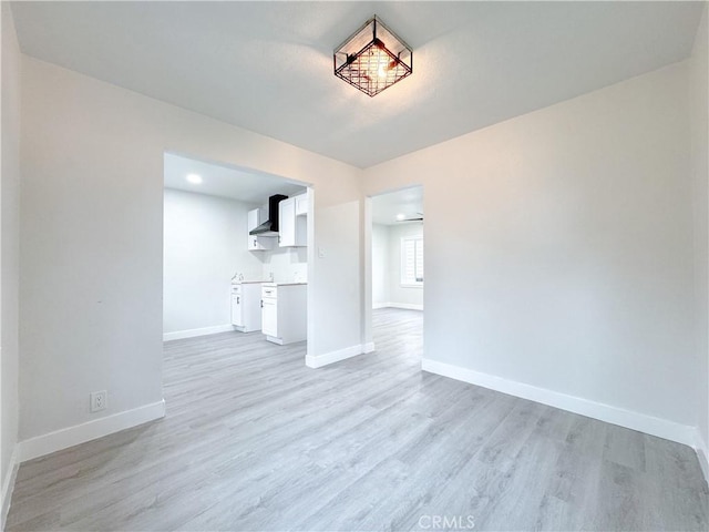 5557 Lemon Ave, Long Beach, CA 90805 - unfurnished living room featuring baseboards, light wood-style flooring, and recessed lighting