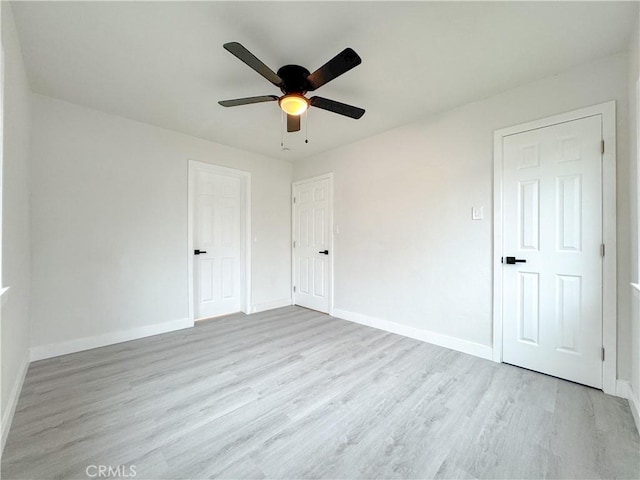 5557 Lemon Ave, Long Beach, CA 90805 - unfurnished bedroom featuring wood finished floors, baseboards, and ceiling fan