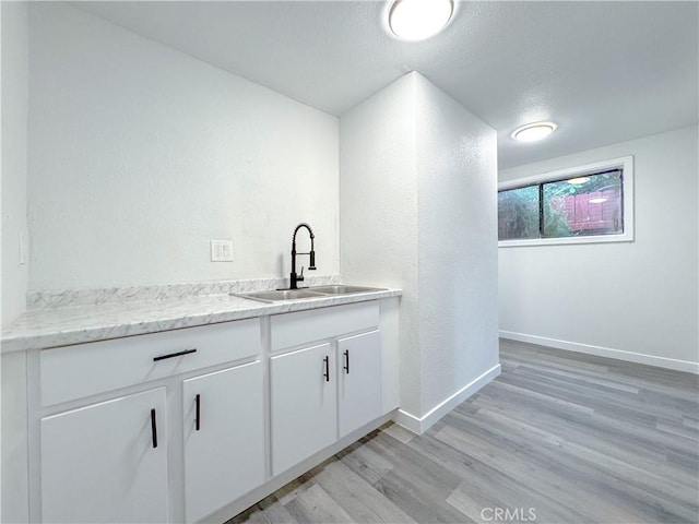 5557 Lemon Ave, Long Beach, CA 90805 - bar with a sink, light wood-style floors, and baseboards