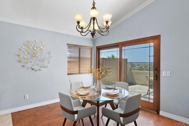 dining space with a chandelier, baseboards, wood finished floors, and crown molding