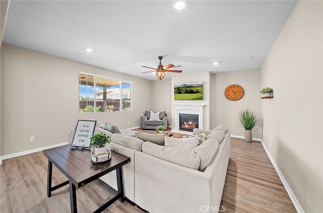 27490 Grand Teton Ct, Menifee, CA 92585 - living room with a ceiling fan, baseboards, wood finished floors, a glass covered fireplace, and recessed lighting