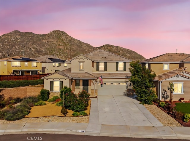 27490 Grand Teton Ct, Menifee, CA 92585 - traditional-style home featuring driveway, a garage, a mountain view, stucco siding, and stone siding