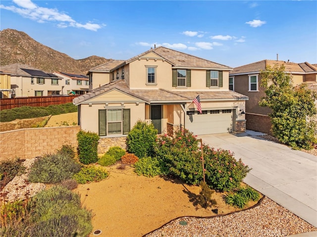 27490 Grand Teton Ct, Menifee, CA 92585 - traditional-style house with stucco siding, stone siding, an attached garage, and driveway