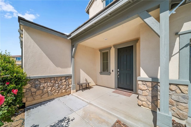 27490 Grand Teton Ct, Menifee, CA 92585 - view of exterior entry with stone siding and stucco siding