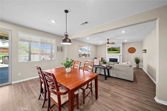 27490 Grand Teton Ct, Menifee, CA 92585 - dining space featuring baseboards, wood finished floors, a fireplace, a ceiling fan, and recessed lighting