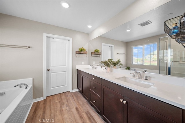 27490 Grand Teton Ct, Menifee, CA 92585 - full bathroom featuring double vanity, a garden tub, wood finished floors, a stall shower, and recessed lighting