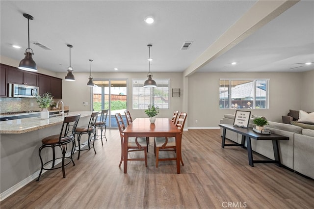 27490 Grand Teton Ct, Menifee, CA 92585 - dining room with light wood-style flooring, baseboards, and recessed lighting