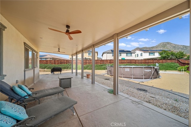 27490 Grand Teton Ct, Menifee, CA 92585 - fenced backyard featuring a patio, ceiling fan, and grilling area