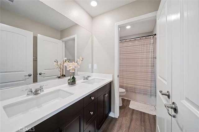 27490 Grand Teton Ct, Menifee, CA 92585 - bathroom featuring toilet, double vanity, wood finished floors, curtained shower, and recessed lighting